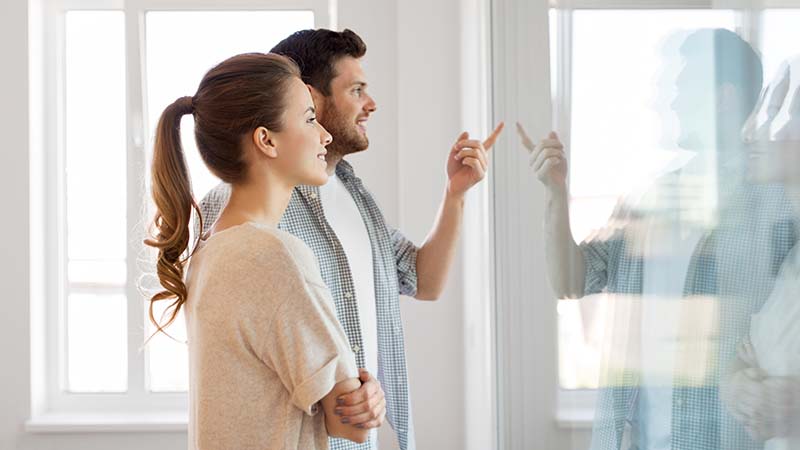 Couple walking through their new house with their home inspector after their home inspection services